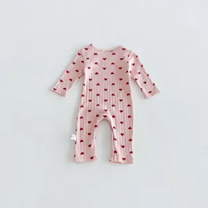 Pink ribbed cotton baby romper detail, cute red heart allover print, long sleeves design.