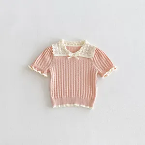 Pink knit top detail view, short sleeves, hollow-out lace collar, sweet style for girls.