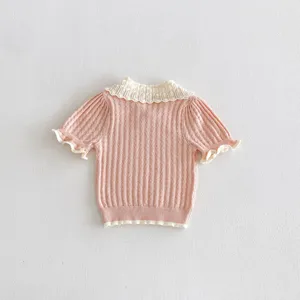 Charming pink girls knit top featuring a cute white ruffled collar and short sleeves.