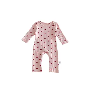 Pink ribbed baby romper with red heart print, long sleeves, cute cotton jumpsuit for newborns.