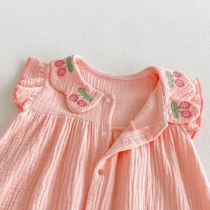 Cute baby girl pink romper with cherry embroidery, ruffle sleeves and snap buttons for summer.