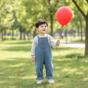 Detailed view of kids denim jumpsuit, cute baby casual overalls featuring comfortable design.