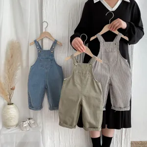 Detailed view of cute children's casual overalls displayed with hangers in various styles.