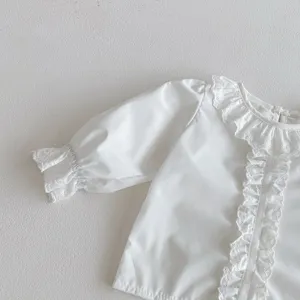 Infant baby white long sleeve blouse with delicate lace collar and ruffle cuffs detail.