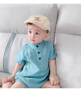 Baby short-sleeve romper detail view showcasing soft fabric and cute matching hat design.