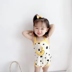 Infant cotton summer romper detail view, featuring cute cow print and moon design with yellow trim.