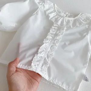 Infant baby white long sleeve blouse with delicate lace collar and ruffle front detail.