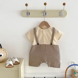 Details of baby short-sleeve romper with cute doll collar and stylish plaid pattern design.