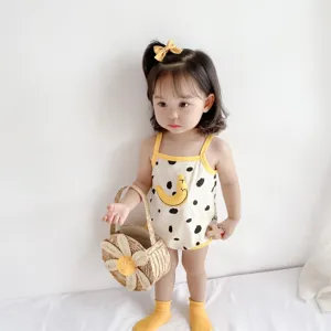 Detail shot of a cute baby summer camisole romper with cute dot and moon print design.