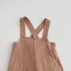 Baby romper detail, cross back straps design, soft breathable fabric, cute infant clothing.
