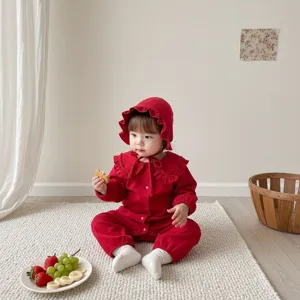 Jolie combinaison bébé fille rouge à manches longues avec col à volants et bonnet assorti.