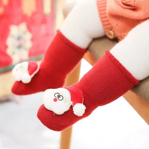 Close-up detail of thickened baby Christmas socks with cute 3D Santa doll for cozy winter.