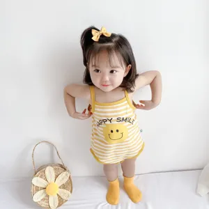 Detailed view of cute baby cotton strap romper with yellow stripes and happy smile print.
