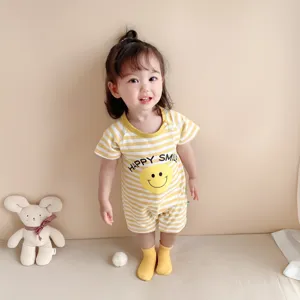 Detailed view of cute baby romper with smiley face print, comfortable summer infant clothing.