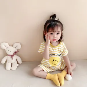 Infant summer short sleeve striped baby romper detail view with cute yellow smiley face design.