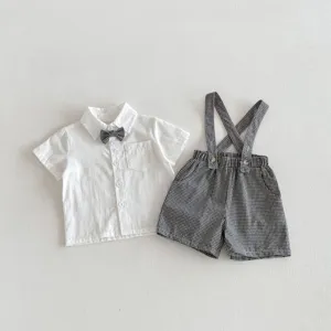 Toddler boy summer shirt and suspender shorts outfit detail, black and white plaid design.