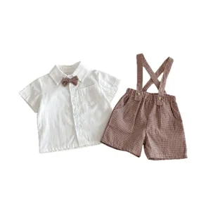 Cute baby boy summer short sleeve white shirt and brown plaid suspender shorts clothing set.