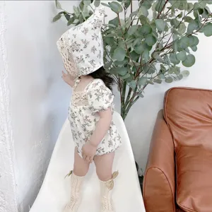 Details of toddler floral romper set with lace bonnet and socks, soft and breathable fabric.
