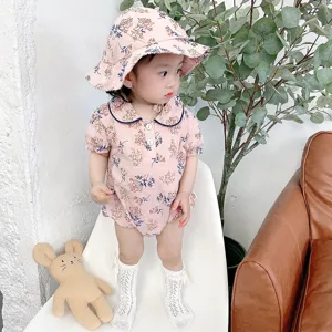 Detail shot of baby summer floral romper and matching hat, cute Korean style baby clothing set.