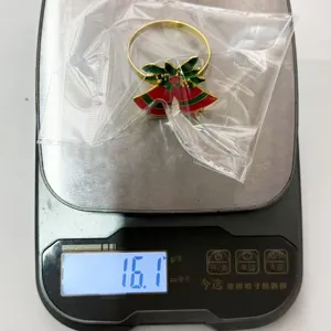 Christmas bell napkin ring detail view showing the exact product weight on scale.