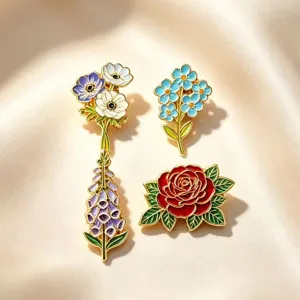 Close-up van delicate bloemvormige emaille broche set, prachtig metalen handwerndetail.