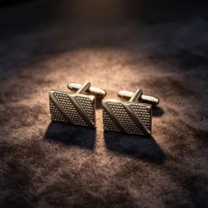 Detailed close-up of square metallic cufflinks with textured pattern for formal men suits.