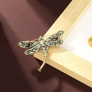 Vintage dragonfly brooch pin for women apparel, antique gold tone fashion jewelry item.