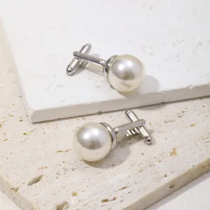 Detail shot of elegant pearl cufflinks for formal French shirts, minimalist design.
