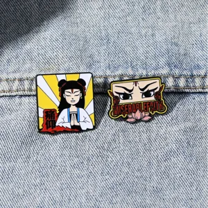 Detailed close-up of metal enamel band badges featuring cartoon art and text on denim fabric.
