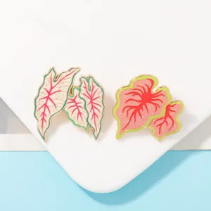 Detail shot of tropical plant leaf enamel brooches, cute alloy pin accessories for bags and clothes.