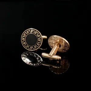 Vue rapprochée des boutons de manchette ronds de luxe dorés avec motif grec élégant.