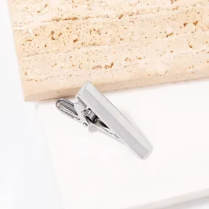Stainless steel men tie clip close up view, minimalist design silver metal suit accessory detail.