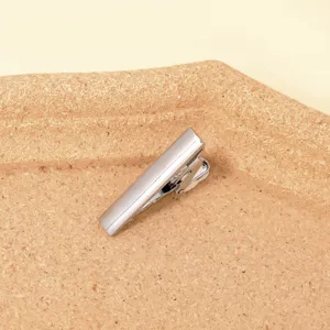 Stainless steel men's tie clip detail shot, simple polished surface design for shirt and suit.