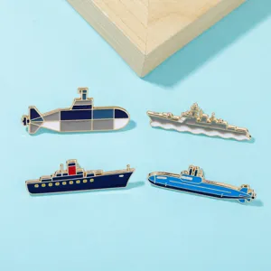 Detailed close-up of cartoon military submarine and warship enamel lapel pins, alloy badge set.