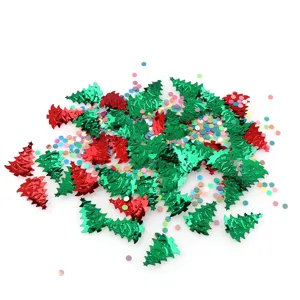 Detail shot of metallic red and green Christmas tree confetti sequins for holiday party decor.