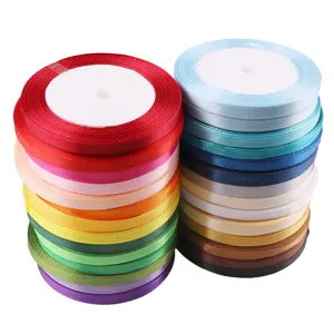 Detailed view of colorful satin ribbon rolls, perfect for gift packaging and DIY decoration crafts.