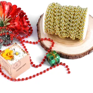 Gold and red bead chains for Christmas wedding DIY decorations, elegant pearl curtain detail.