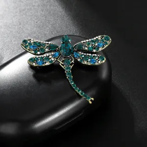 Exquisite rhinestone dragonfly brooch detail shot, vintage crystal lapel pin accessory.