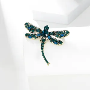 Exquisite vintage dragonfly brooch detail, sparkling blue and green crystal rhinestones.