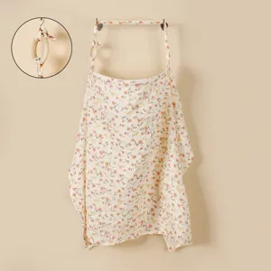 Baby nursing cover detail showing floral print cotton gauze and wooden ring for breastfeeding.