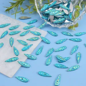 Close-up detail view of blue horse eye flatback rhinestones for nail art and DIY jewelry crafts.