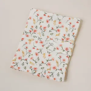 Detalle de funda de libro de tela, vista cercana de cubierta floral para cuaderno.