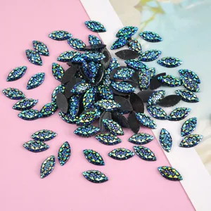 Close-up of blue green iridescent resin horse eye rhinestones for DIY handmade craft 7x15mm