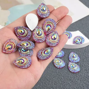 Closeup of 18x24mm teardrop resin rhinestones featuring vibrant AB color and sparkling glitter.