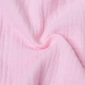 Primer plano detalle de tela de gasa de algodón de doble capa rosa, textura de muselina.