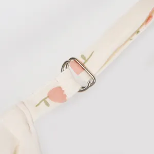 Detailed close-up view of cotton nursing cover strap featuring metal adjuster and lovely tulip print