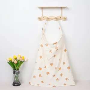Detailed showcase of soft cotton nursing cover featuring cute mushroom print pattern.