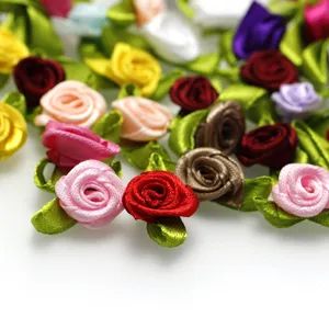 Close-up detail of colorful ribbon roses with green leaves for DIY apparel decoration crafts