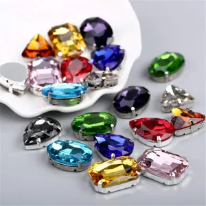Detailed close-up view of colorful glass claw rhinestones in mixed shapes and bright facets.