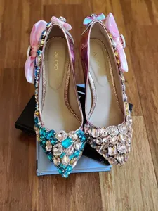 Rhinestone high heels with pink bow and crystal embellishments, elegant women dress shoes detail.